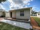 Tan house with green door and small patio at 32314 Oak Park Dr, Leesburg, FL 34748