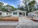 Single-story home with carport and landscaped yard at 32314 Oak Park Dr, Leesburg, FL 34748