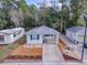 Single-story home with carport and landscaped yard at 32314 Oak Park Dr, Leesburg, FL 34748