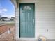 Teal front door with a semi-circular window at 32314 Oak Park Dr, Leesburg, FL 34748