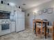 White kitchen features white cabinets, appliances, and tile floor at 32314 Oak Park Dr, Leesburg, FL 34748