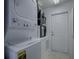 Stackable washer and dryer in a well-lit laundry room at 32314 Oak Park Dr, Leesburg, FL 34748