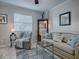 Relaxing living room, featuring a sofa and armchair at 32314 Oak Park Dr, Leesburg, FL 34748