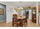 Charming dining room features a wood table and chairs at 3447 Ridgewood Path, The Villages, FL 32163