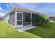 Screened porch with patio furniture and tropical plants at 3447 Ridgewood Path, The Villages, FL 32163