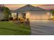 Well-maintained house, nicely landscaped yard, and a two-car garage at sunset at 3786 Infinity Run, The Villages, FL 32163