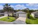 Single-story home with landscaped yard and driveway at 3786 Infinity Run, The Villages, FL 32163