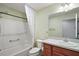 Bathroom with tub, shower, toilet and wood vanity at 3810 Cosmos Way, The Villages, FL 32163