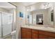 Bathroom with double vanity and shower at 3810 Cosmos Way, The Villages, FL 32163
