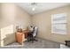 Home office with wood desk, chair, and window with blinds at 3810 Cosmos Way, The Villages, FL 32163