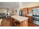 Open concept kitchen with island and stainless steel appliances at 3810 Cosmos Way, The Villages, FL 32163