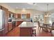Spacious kitchen with island, stainless steel appliances, and wood cabinets at 3810 Cosmos Way, The Villages, FL 32163