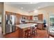 Kitchen with island, stainless steel appliances, and wood cabinets at 3810 Cosmos Way, The Villages, FL 32163