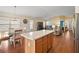 Eat-in kitchen with island and view into living room at 3810 Cosmos Way, The Villages, FL 32163