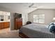 Main bedroom with ceiling fan and ensuite bathroom at 3810 Cosmos Way, The Villages, FL 32163