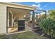 Screened patio with seating area and grill at 3810 Cosmos Way, The Villages, FL 32163