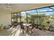 Relaxing screened patio with seating area, brick flooring, and lush landscaping views at 3810 Cosmos Way, The Villages, FL 32163