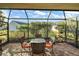 Screened patio with brick flooring and outdoor furniture at 3810 Cosmos Way, The Villages, FL 32163
