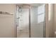 Clean shower with sliding glass doors and built-in shelves at 3810 Cosmos Way, The Villages, FL 32163