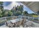 Deck with table and chairs, overlooking a large backyard at 422 W 11Th Ave, Mount Dora, FL 32757