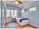 Light blue bedroom with twin bed and wood floors at 422 W 11Th Ave, Mount Dora, FL 32757