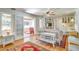 Bright living room featuring hardwood floors, white wicker furniture, and access to a porch at 422 W 11Th Ave, Mount Dora, FL 32757
