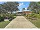 Long driveway leading to a two-car garage at 42714 Royal Trails Rd, Eustis, FL 32736