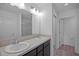Bathroom with double vanity and dark brown cabinets at 5820 Bamboo Ave, The Villages, FL 32163