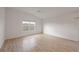 Spacious bedroom with hardwood floors and large window at 5820 Bamboo Ave, The Villages, FL 32163
