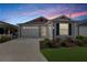 Gray house with red accents and a two-car garage at 5820 Bamboo Ave, The Villages, FL 32163