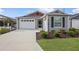 Gray house with red accents and a two-car garage at 5820 Bamboo Ave, The Villages, FL 32163
