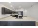Modern kitchen with dark cabinetry, stainless steel appliances, and an island at 5820 Bamboo Ave, The Villages, FL 32163