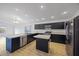 Modern kitchen with dark cabinetry, stainless steel appliances, and an island at 5820 Bamboo Ave, The Villages, FL 32163