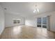 Bright living room with hardwood floors and sliding doors at 5820 Bamboo Ave, The Villages, FL 32163