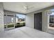 Covered screened porch with ceiling fan and access door at 5820 Bamboo Ave, The Villages, FL 32163