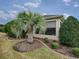 Well-maintained backyard featuring a palm tree and lush landscaping at 630 Laurel Run, The Villages, FL 32162