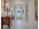 Bright and airy entryway with tile floors, console table, and artwork at 630 Laurel Run, The Villages, FL 32162