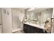 Elegant bathroom with double vanity, shower, and decorative accents at 716 Se 64Th Ter, Ocala, FL 34472