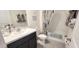 Clean bathroom with a tub, shower, and white vanity with dark cabinets at 716 Se 64Th Ter, Ocala, FL 34472