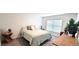 Cozy bedroom with a queen-size bed, nightstand, and wood dresser at 716 Se 64Th Ter, Ocala, FL 34472