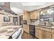 Kitchen with wood cabinets, granite countertops, and stainless steel appliances at 73 Stone Haven Ct, Leesburg, FL 34788