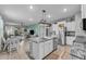 Modern kitchen with white cabinets, granite counters, and island at 8045 Penrose Pl, Wildwood, FL 34785