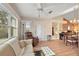 Cozy living room featuring a comfy sofa and recliner, and access to the back patio at 821 Ramos Dr, The Villages, FL 32159