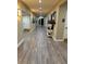 Bright hallway with wood-look flooring and tasteful decor at 8293 Bridgeport Bay Cir, Mount Dora, FL 32757