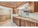 Bathroom with granite countertops, wood cabinets, and a large mirror at 9029 Mossy Oak Ln, Clermont, FL 34711