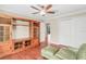 Comfortable bedroom with hardwood floors, built-in shelving, and ceiling fan at 9029 Mossy Oak Ln, Clermont, FL 34711