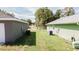 View of the backyards of two houses with AC units at 91 Locust Loop, Ocala, FL 34472