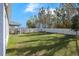 Fenced backyard with grassy area and trees at 1109 Catskill Dr, Haines City, FL 33844