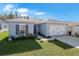 Gray house with two car garage and well maintained lawn at 1109 Catskill Dr, Haines City, FL 33844