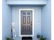 Gray front door with white trim and 'Home Sweet Home' decor at 1109 Catskill Dr, Haines City, FL 33844